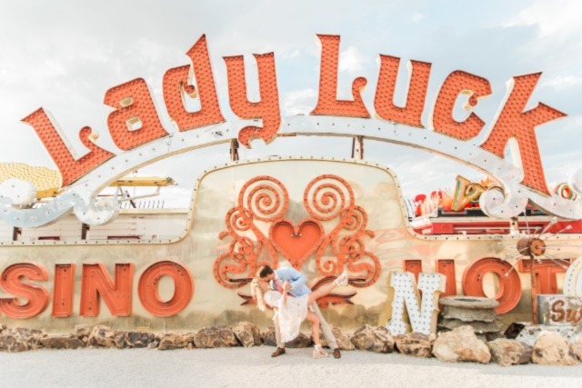 Couple kissing under Lady Luck Neon Sign 4 640